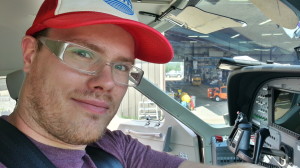 Don't let the smile fool you. I'm suffering a coup-de-tonsil. Sitting next to the pilot seat on the way to Fort McMurray.